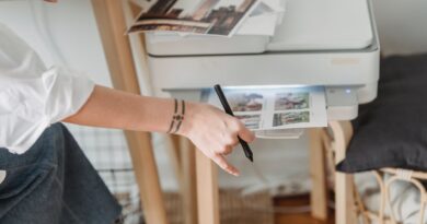 woman printing photos on paper while forking at home
